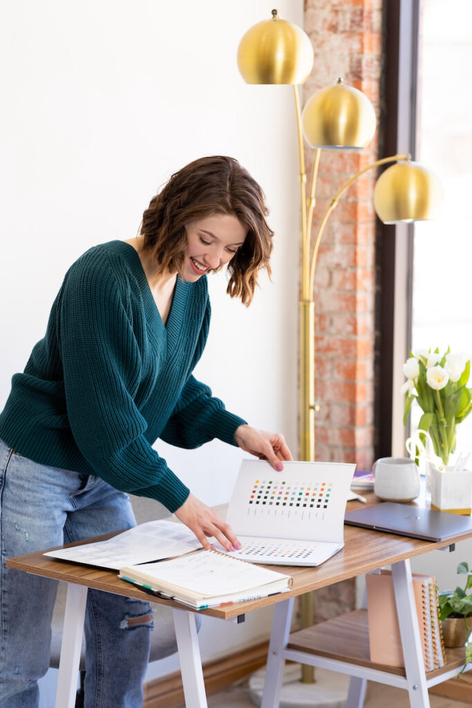 brand and web designer Ellie Brown works on a brand design at her desk